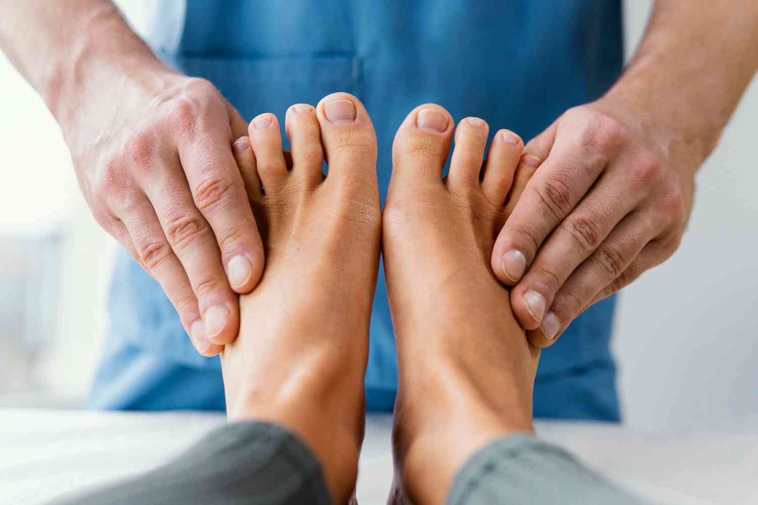 front-view-of-male-osteopathic-therapist-checking-female-patient-s-toes